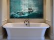 Ceramic tile mural of a sailing ship in a stormy sea with dark clouds and dramatic waves