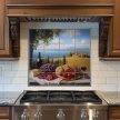 Ceramic tile mural with Tuscan landscape, bread, wine, grapes, cheese and tomatoes on a table
