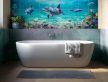 Bathroom tile mural with dolphins, tropical fish, and coral reef