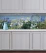 Tile mural with agapanthus, hydrangea, and delphinium in front of a coastal landscape