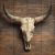Tile mural with longhorn skull and wooden background