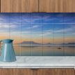 Ceramic tile mural of Badacsony at sunset with a rowing boat and lake reflections