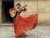 Expressive tile mural featuring a flamenco dancer in a vibrant red dress, passionately playing a Spanish guitar.