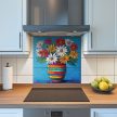 Tile mural with vivid daisies in a multicolored striped vase on a blue background