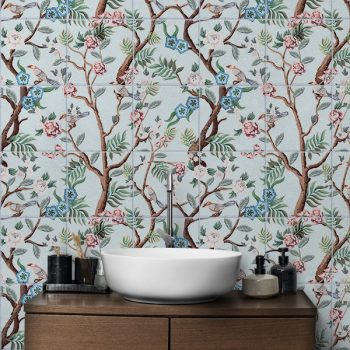 Chinoiserie tile mural with brown branches, pink and blue flowers, and decorative birds on light blue background