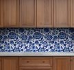 Chinoiserie-style ceramic tile mural with blue floral and leaf motifs on white background