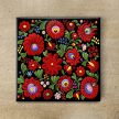 Hungarian Matyó pattern tile trivet and ceramic mug with colorful Hungarian folk floral motifs