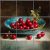 Cranberry still life ceramic tile mural with blue bowl and green leaves