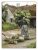 Ceramic tile mural with elderly woman herding geese in front of a thatched country house