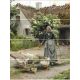 Ceramic tile mural with elderly woman herding geese in front of a thatched country house